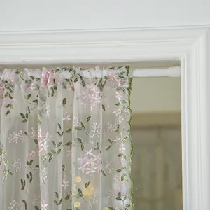 Sheer short door curtain with pink floral embroidery and green scalloped edges for room.