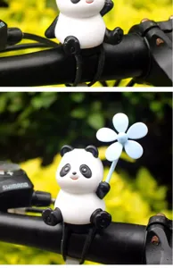 Cute panda bicycle handlebar decoration detail shot, wind spinner accessory close-up view.