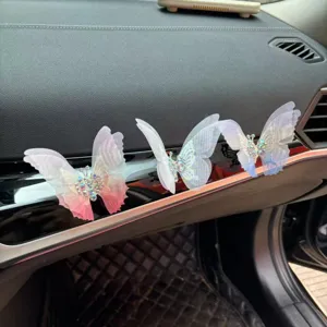 Decorative butterfly car dashboard ornament with shimmering rhinestones and shiny wing design.