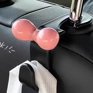 Cute pink bow car seat hook for backrest storage, stylish car interior accessory and organizer.