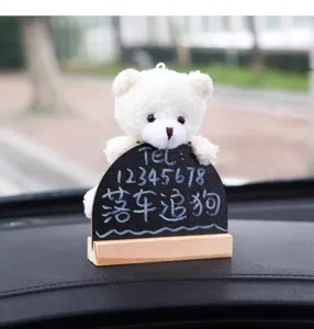 Cute plush bear temporary parking card detail, car dashboard ornament with blackboard.