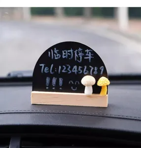 Close-up detail of the creative wooden blackboard temporary parking card with cute mushroom decor.