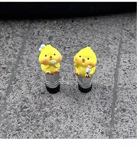 Cute yellow chick tire valve caps, creative decorative stem covers for cars and bikes.