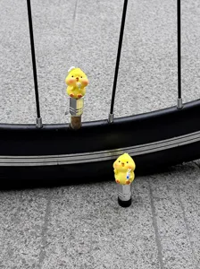 Cute yellow chick bike tire valve caps, decorative dust covers for bicycle air nozzles.