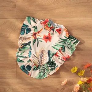 Chic Hawaiian floral pet cape with ruffles and cute bow, perfect summer beach wear for dogs.