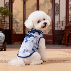 Detailed view of a cute dog wearing a blue floral pet cheongsam dress in a traditional setting.