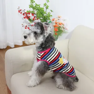 Detailed shot of cute pet dog wearing colorful striped vest with cartoon print and round neck style.