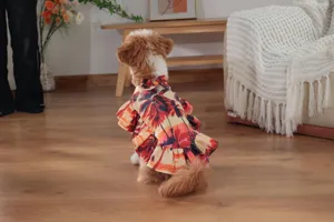 Detailed view of cute pet Hawaiian vacation cape dress with tropical sunset palm tree print ruffles.