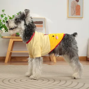 Close-up detail of cute cartoon pet t-shirt with yellow fabric and red trim worn by dog.