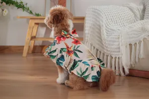 Tropical floral dog cape detail view, cute pet summer dress with ruffles and bow tie for vacation.