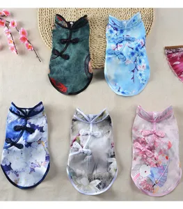 Detailed view of cute summer pet qipao dresses for small dogs like poodles, featuring floral prints.