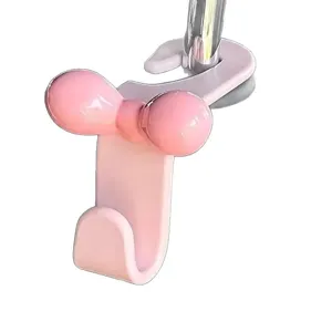 Cute pink bow car headrest hook for back seat storage, practical car interior accessory.
