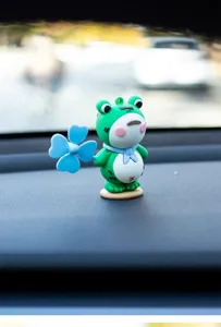 Cute green frog car dashboard ornament with blue pinwheel toy interior decoration accessory