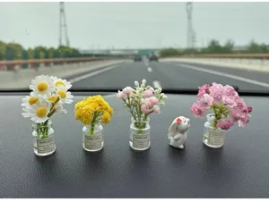 Miniature car ornament detail showcasing cute glass vases with flowers and rabbit.