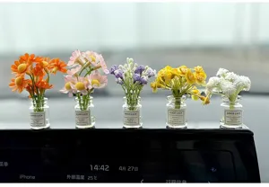 Miniature artificial flower vases detail view, cute floral car dashboard decor and small display.