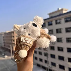 Cute plush Westie puppy keychain bag charm, fluffy cartoon dog pendant with knitted hat.