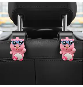 Detailed view of cute pink cartoon bear car seat hook installed on headrest pillars.