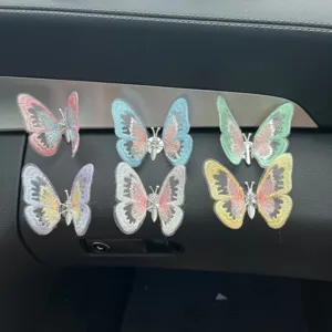 Detailed view of colorful butterfly car air vent clips, decorative interior ornaments.