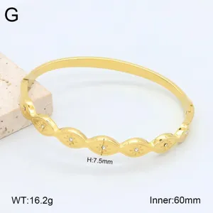 Bracelet jonc en acier inoxydable doré avec motifs d'yeux en cristal et dimensions.