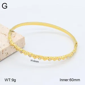 Détail bracelet jonc cœur strass en acier inoxydable doré, diamètre 60mm, bijoux élégant.