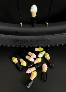 Cute ice cream cone tire valve caps detail shot, colourful bicycle wheel accessories for bikes.