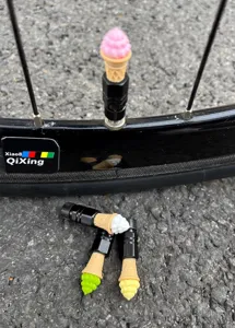 Ice cream bicycle valve caps detail showing colorful cone designs installed on tires.