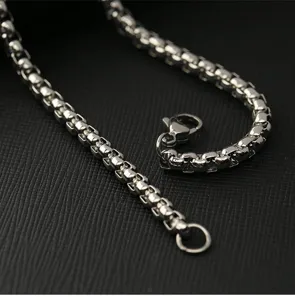 Vue de détail en gros plan du collier chaîne en perles carrées en acier vintage.