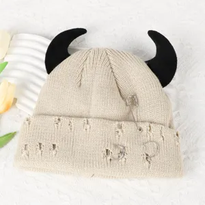 Cute devil horn knitted beanie hat with metal pin and distressed holes for autumn and winter.