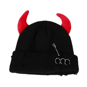 Black knit beanie with red devil horns, safety pin and metal rings, punk style winter hat.