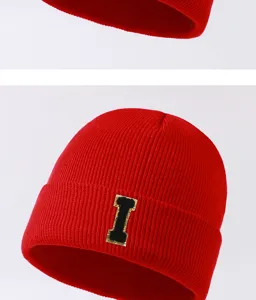 Red knit beanie hat with letter patch, winter warm brimless skull cap for men and women outdoor.
