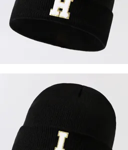 Black knit beanie hat for winter, warm casual streetwear with stylish letter patch embroidery.