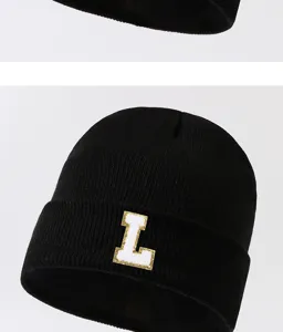 Black knitted beanie hat with white letter L patch, warm winter fashion streetwear.