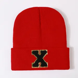 Red knit beanie hat with letter X patch, trendy winter warm ski cap for men and women.