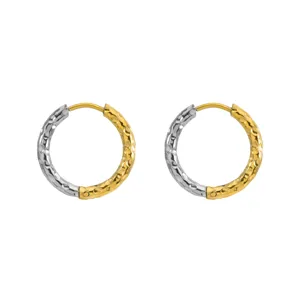 Detail shot of two-tone hammered texture hoop earrings in gold and silver finish