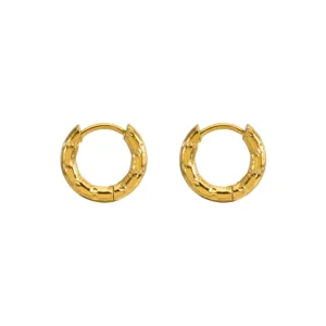 Close-up view of gold stainless steel hoop earrings with a textured hammered finish.