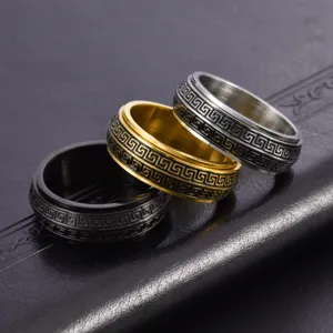 Detailed view of three stainless steel spinning rings for men with meander patterns