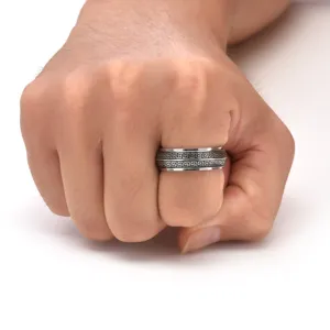 Detail view of men's stainless steel spinner ring with black engraved fret pattern