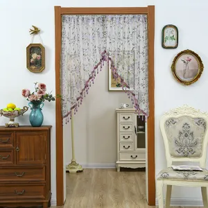 Lace door curtain with floral print and beaded fringe, perfect for bedroom privacy decor.