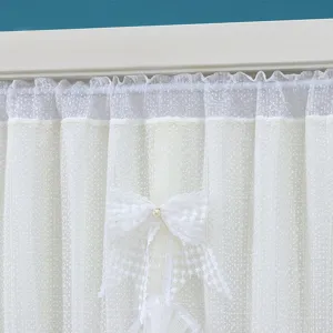 White lace curtain detail shot, elegant window partition with bow knot accent for home decor
