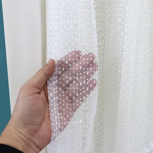 Close-up view of white lace mesh curtain fabric showing fine texture and breathable design.