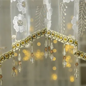 Detailed view of French vintage lace short curtain with elegant embroidery and beaded fringe.