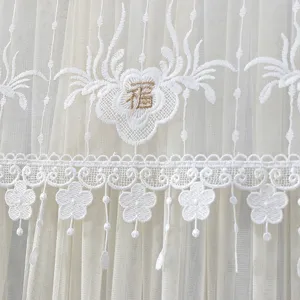 White lace curtain detail shot featuring exquisite floral embroidery and elegant hollow lace trim.