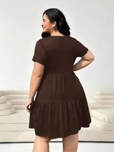 Detail view of a solid brown short sleeve tiered plus size dress, casual fashion style.