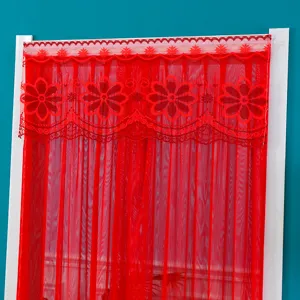 Red lace curtain detail showcasing intricate floral patterns and breathable fabric texture.