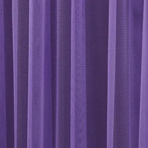 Close up of purple mesh curtain fabric detail showing soft tulle texture and vertical drape.