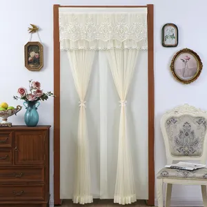 Detailed view of elegant beige lace door curtain with delicate embroidery valance for home.