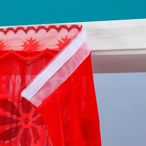 Detail view of red lace mosquito door curtain with white velcro strip, easy installation.