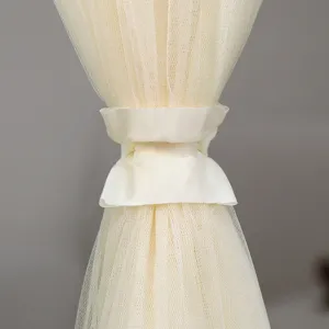 Close-up detail shot of sheer mesh curtain tieback in beige, elegant window treatment accent.