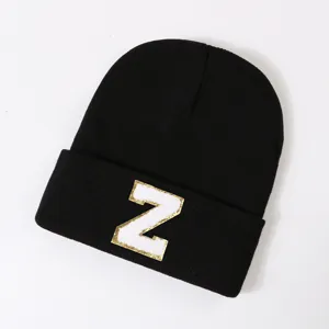 Black knitted beanie hat with stylish letter Z patch, warm winter streetwear for men and women.