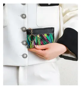 Detailed view of a fashionable colorful geometric print coin purse with keychain holder.